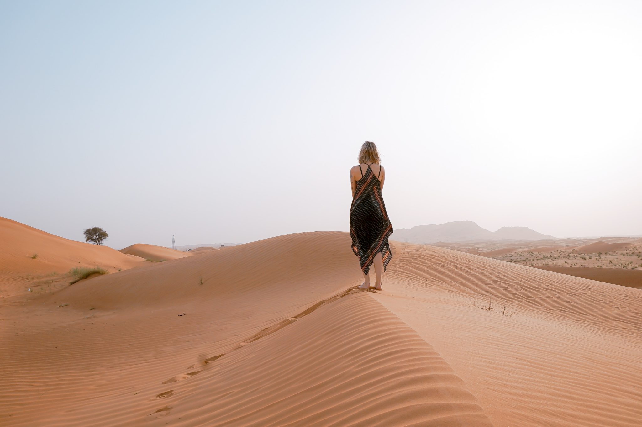 Žena procházející se po poušti u Dubaje